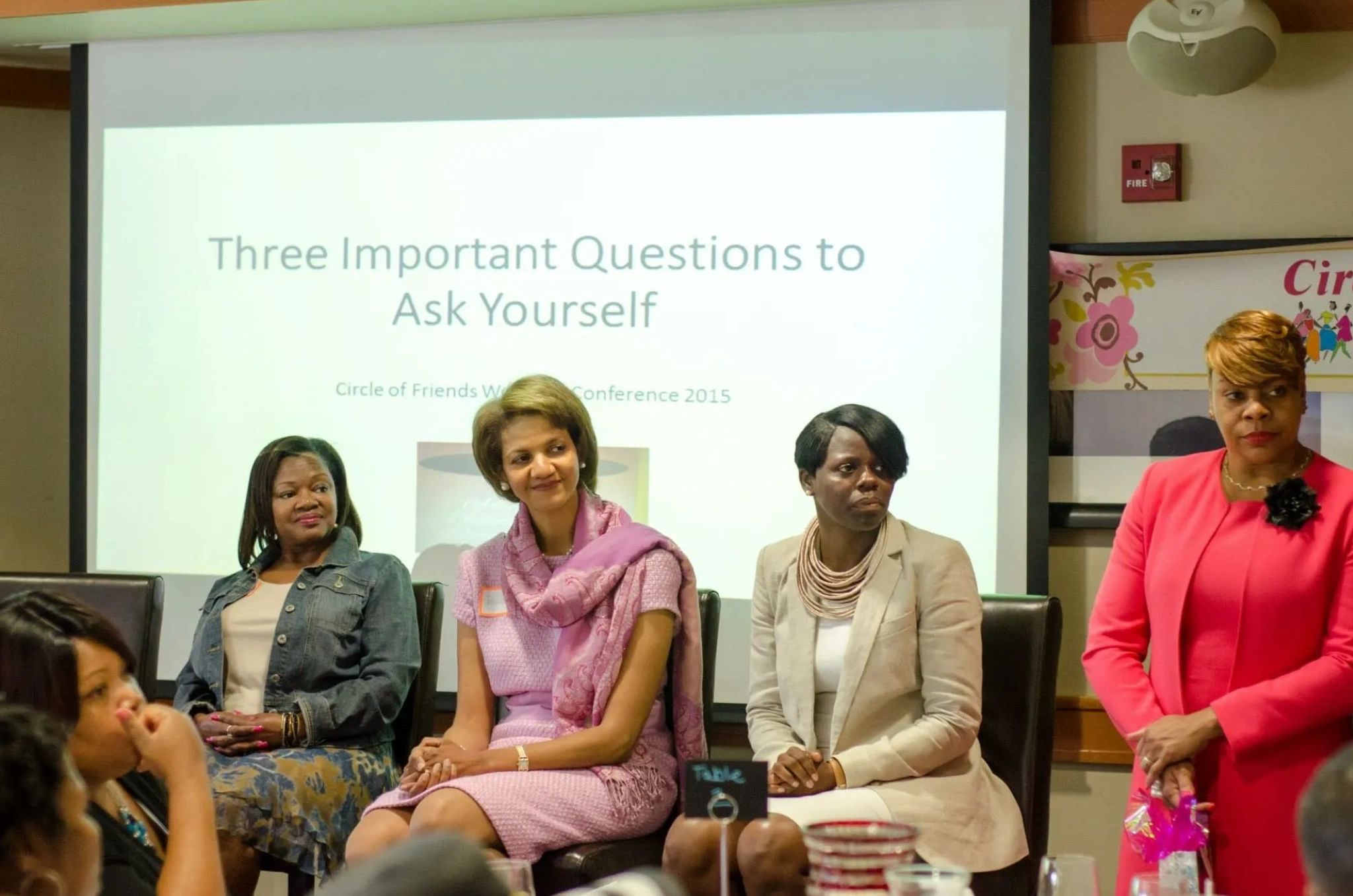 Women speaking at a community conference